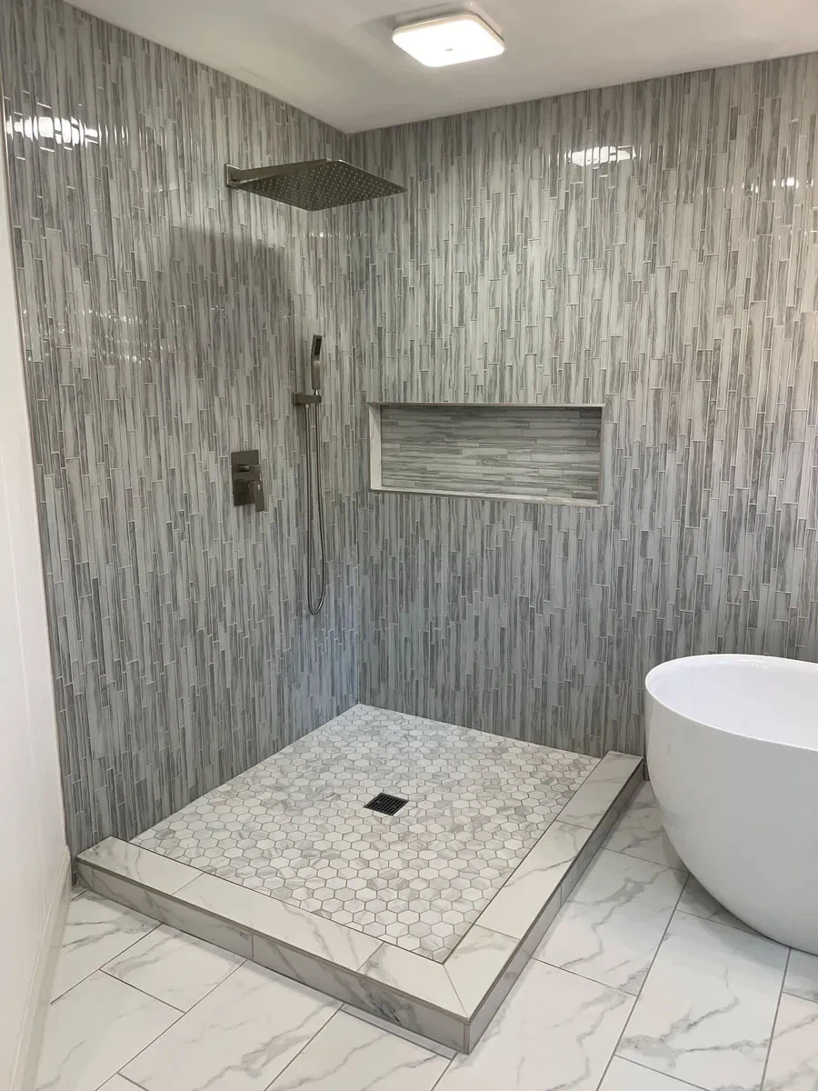 Modern bathroom with mosaic tiles and freestanding bathtub